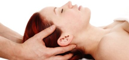 woman getting a head and shoulder massage on white background